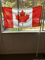 Flag displayed on window with pole leaning