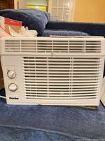 Front view of Danby window air conditioner showing grille, control knobs and logo