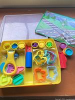 Play-Doh set opened showing tools, cutters, play mat
