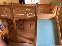 Upper bunk rail with cloud cutouts and slide entry