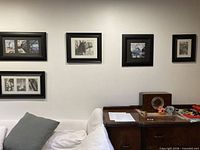 All six framed prints displayed on wall