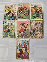 All seven Popeye trading cards laid out