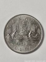 Reverse showing CANADA, voyageurs in canoe, date 1979, denomination DOLLAR