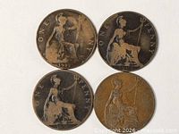 Four British One Penny coins front view
