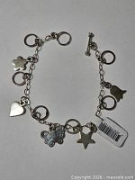 Full view of sterling silver charm bracelet with all charms visible