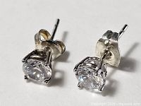 Front view of both sterling silver stud earrings showing clear stones and prong settings