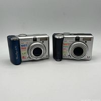 front view showing both Canon PowerShot cameras with lenses and model markings