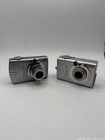 Front view of both Canon cameras with lenses extended