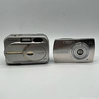 Front view of both cameras showing brand names, lens covers and model details