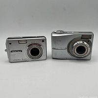 Front view of both cameras showing brands, lenses and model markings
