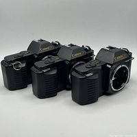 Front angled view of three Canon 750 bodies showing logos and lens mounts
