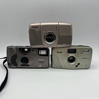 Front view of the three Kodak Advantix cameras highlighting model labels and lens covers
