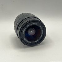 Front oblique view showing front element, focal length and aperture markings, 55 mm filter thread