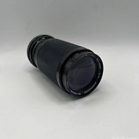 Front oblique view showing front element and barrel