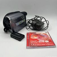 Samsung mini-DVD camcorder, battery, charger cable, and sealed TDK DVD-RW disc