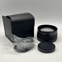 Lens, caps, leather case overall view