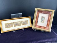 Both framed prints side by side on stands