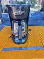 Full view of coffee maker front with carafe and control panel