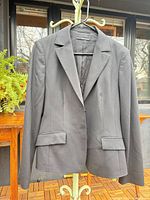 Front view of BOSS black tailored blazer on hanger