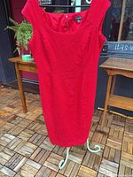 Front view of red sheath dress hanging