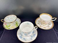 Front view of three teacup and saucer sets