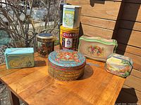 All seven tins displayed on table