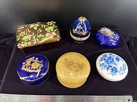 Front view of six trinket boxes showing designs and colours