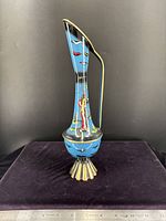 Full frontal view showing shape, painted design, foot, ruler for scale