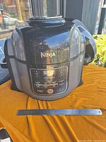Front view of Ninja Foodi multicooker showing control panel and exterior condition