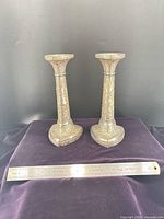Front view of both candlesticks with ruler for scale