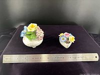 Both figurines with ruler showing scale