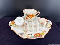 Full set showing platter, teacup, toast rack, egg cup; base mark visible