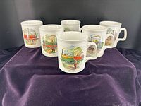 Group view of six locomotive print mugs front side
