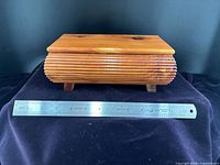 Front view of cedar box with ruler for scale