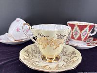 Front view of three teacup and saucer sets