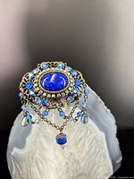 Front view showing cabochon, rhinestones and chain dangles