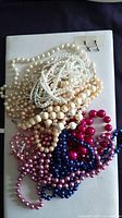 Pile of assorted bead necklaces showing colours and styles