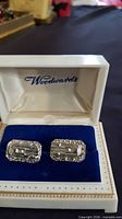 Cufflinks in Woodwards box on blue velvet