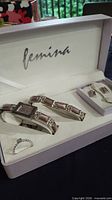 Full view of open Femina case showing all five jewellery pieces arranged inside