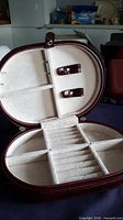 Open case showing interior compartments and ring rolls