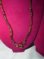 Front view showing full length of crystal bead necklace on display bust