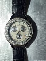 Watch close-up showing dial, chronograph subdials, crystal bezel