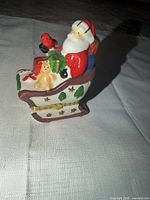 Side view of ceramic Santa sleigh trinket box closed
