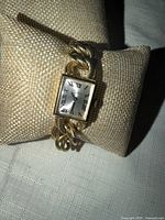 Front view of Chateau watch on display pillow showing dial and bracelet