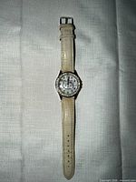 Full view of cream Hello Kitty wristwatch