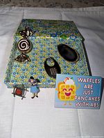 Entire lot showing box, magnet, keychain, pendant, figurine, charm