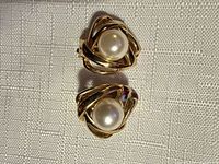 front view of both earrings showing knot design and faux pearls