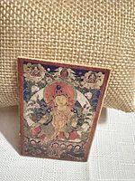 front view showing printed deity artwork on brooch