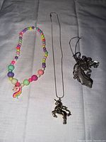 All three necklaces laid out on cloth