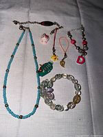 All jewellery and charms laid out on cloth background